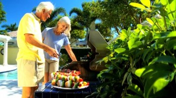 older couple grilling outdoors